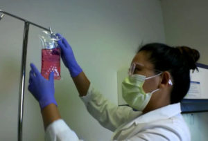 IV nutrition bag being hung up on an IV pole