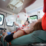medical emergency. Woman inside ambulance with paramedics